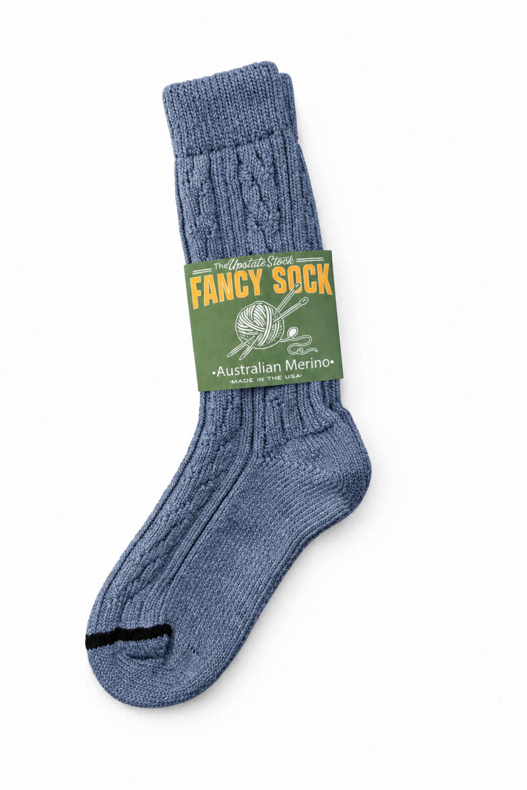A single blue cable-knit sock with a green paper band label reading 'FANCY SOCK Australian Merino', photographed on a clean white background.